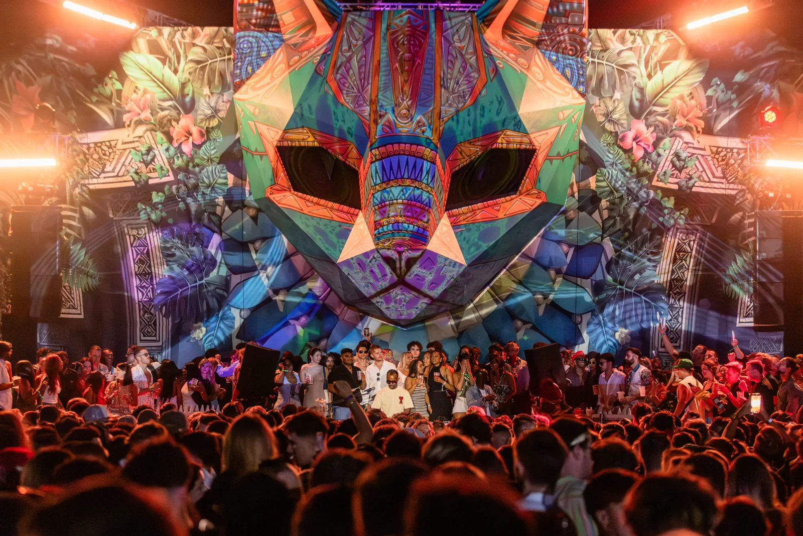 The crowd at the Alcazar main stage under a giant jungle cat mask